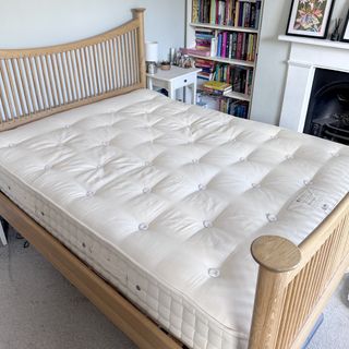 The Hypnos Wool Origins 6 mattress being tested in a bedroom with a wooden bedframe