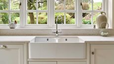 cream Shaker kitchen with double Butler sink under casement window