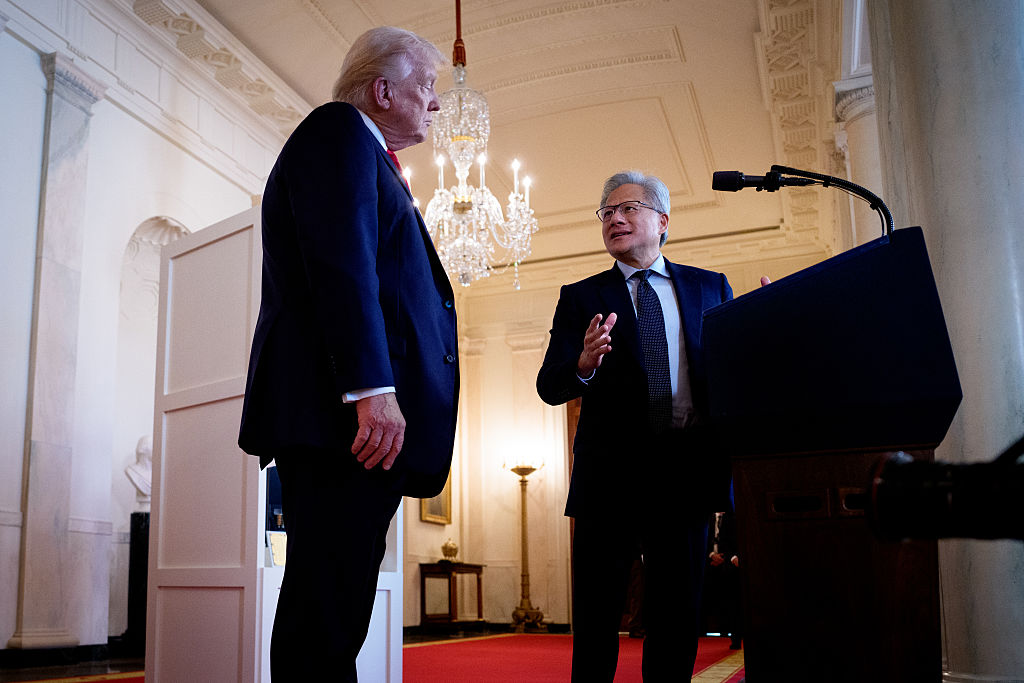 President Donald Trump (L) listens as Nvidia CEO Jensen Huang speaks in the Cross Hall of the White House during an event on "Investing in America" on April 30, 2025