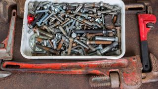 Nuts and screws in a plastic container