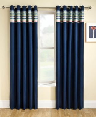 Siesta Blackout Ready Made Curtains in a dark blue slightly open revealing a window
