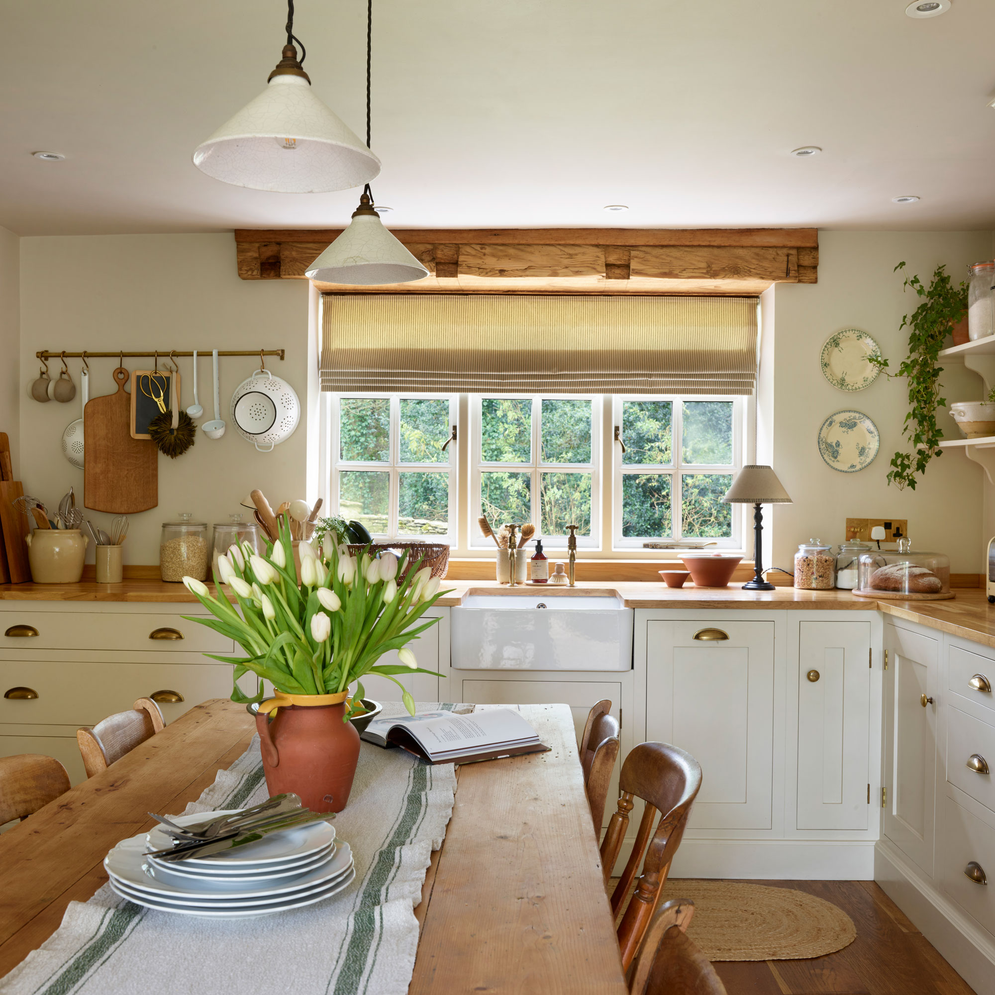 Farmhouse style kitchen with hanging rail and rustic wooden table