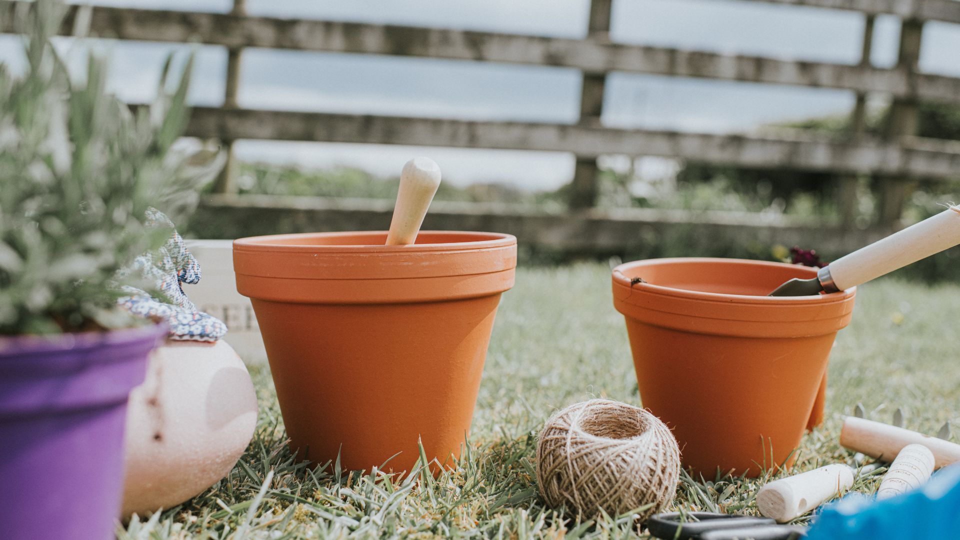 picture of terracota pots being filled with soil with twine next to them