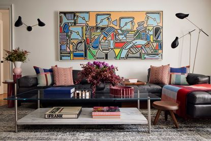 a living room with large artwork above a sofa