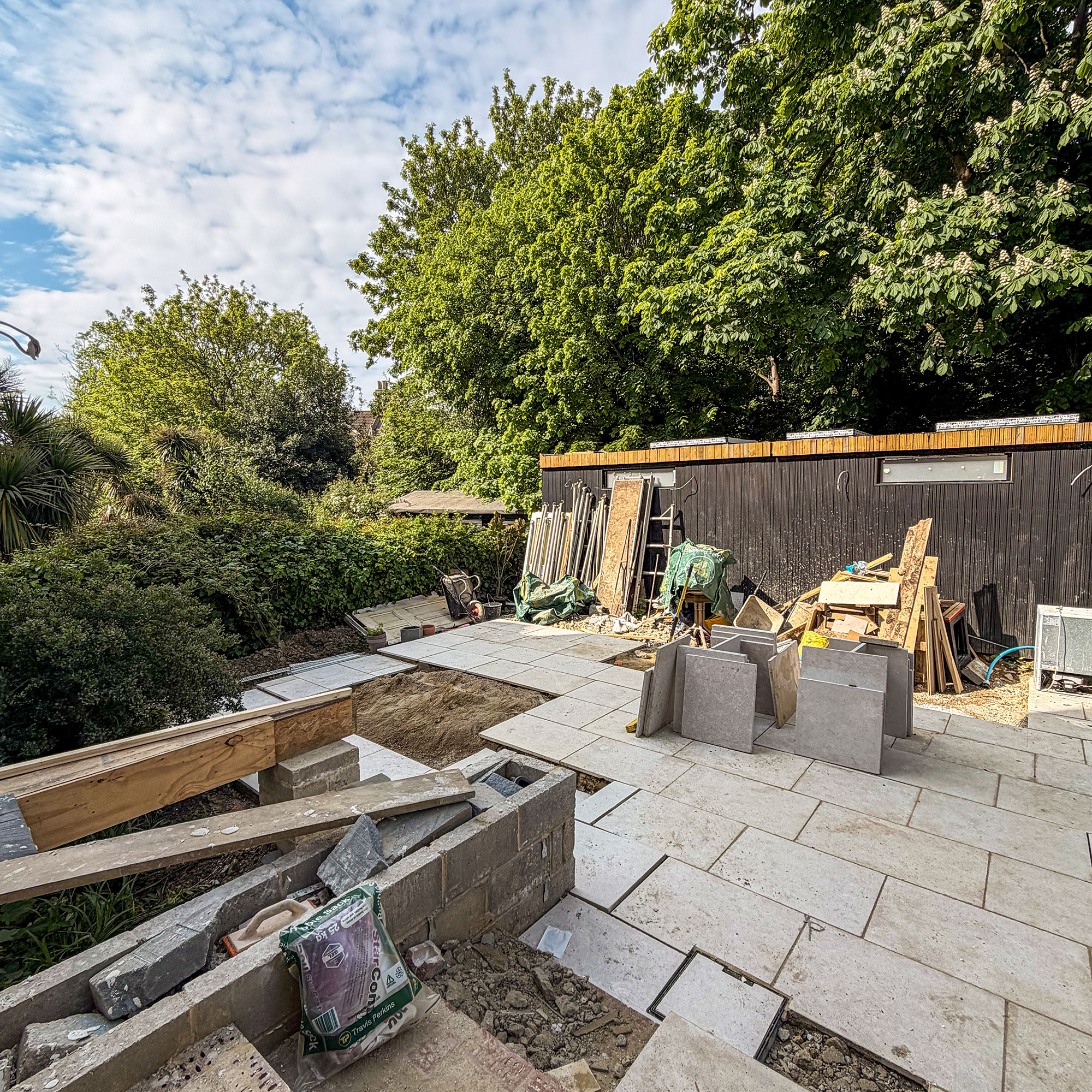 Garden mid-renovation with patio being laid