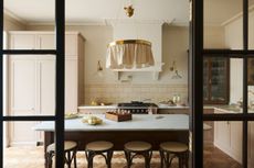 putty beige kitchen with fabric light and subway tiles by deVOL