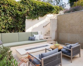 modern backyard living space with seating around a gas fireplace