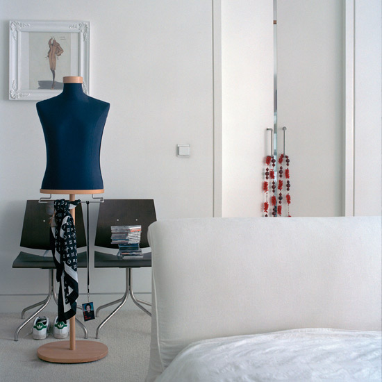 bedroom with white wall and chairs