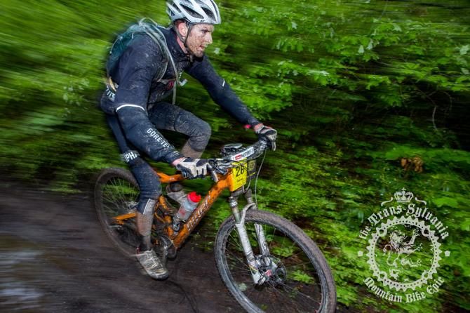 Peter Butt pushing down the muddy mountain doubletrack.