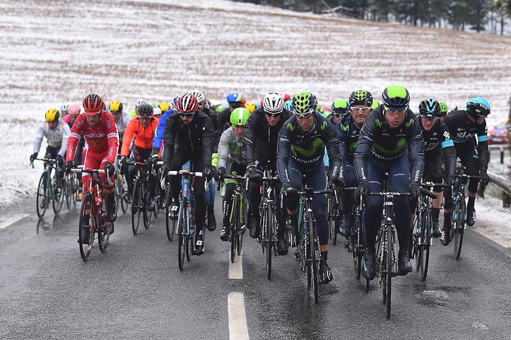The peloton rides together as the snow falls on Paris-Nice.