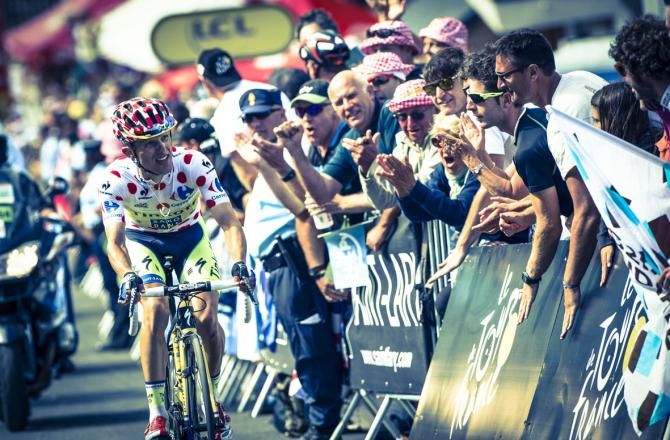Rafal Majka climbs the final metres to Pla d'Adet but spots something in the crowd