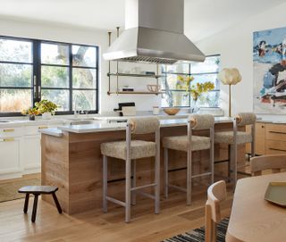 mid century modern meets farmhouse kitchen by K Interiors with boucle bar stools