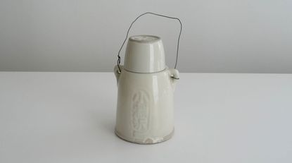 White jug against a grey background