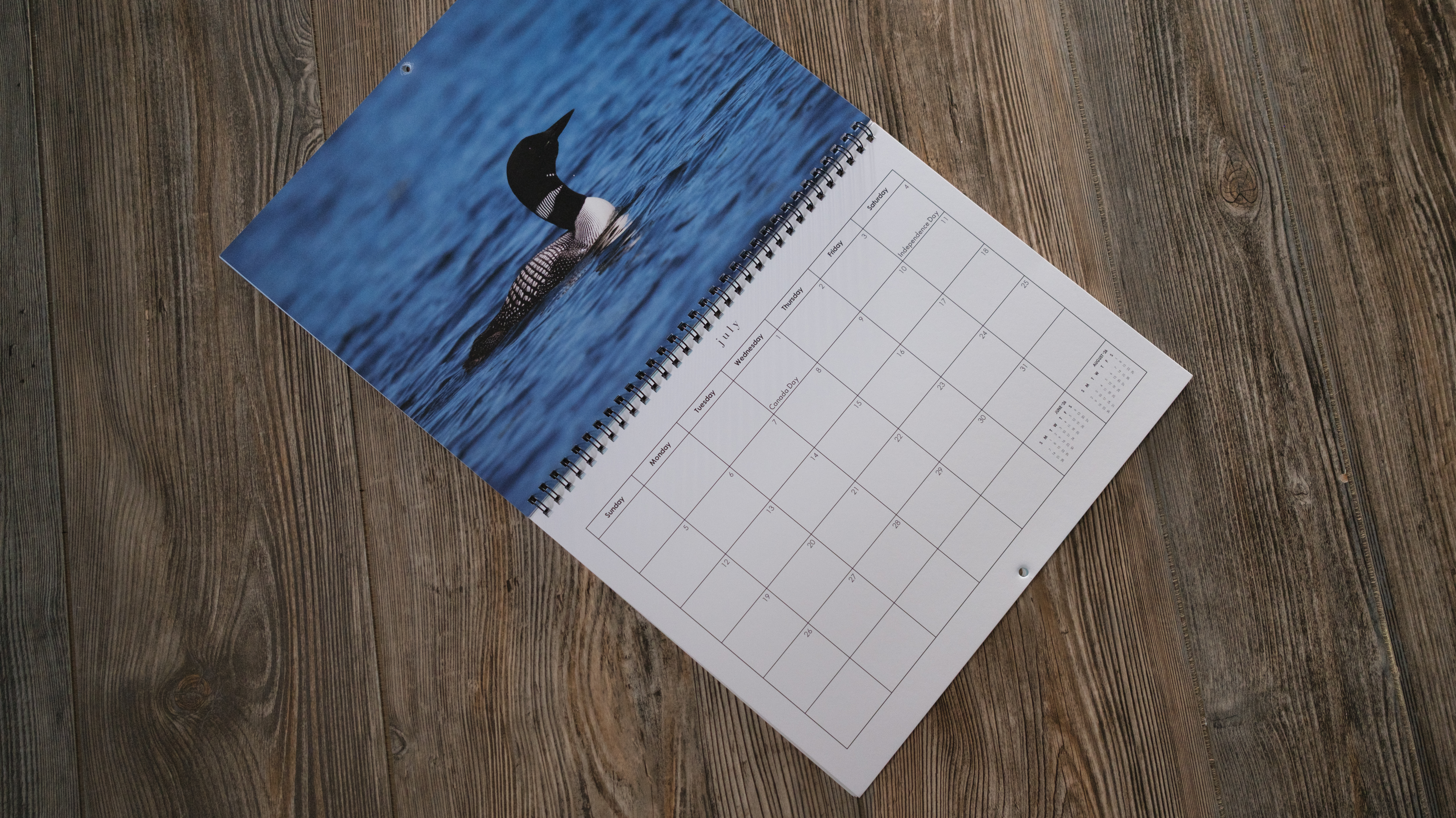 A photo calendar from Mixbook on a wood background