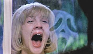 Scream Drew Barrymore is frightened by Ghostface in the glass