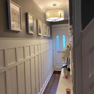 hallway with wooden floor and white door