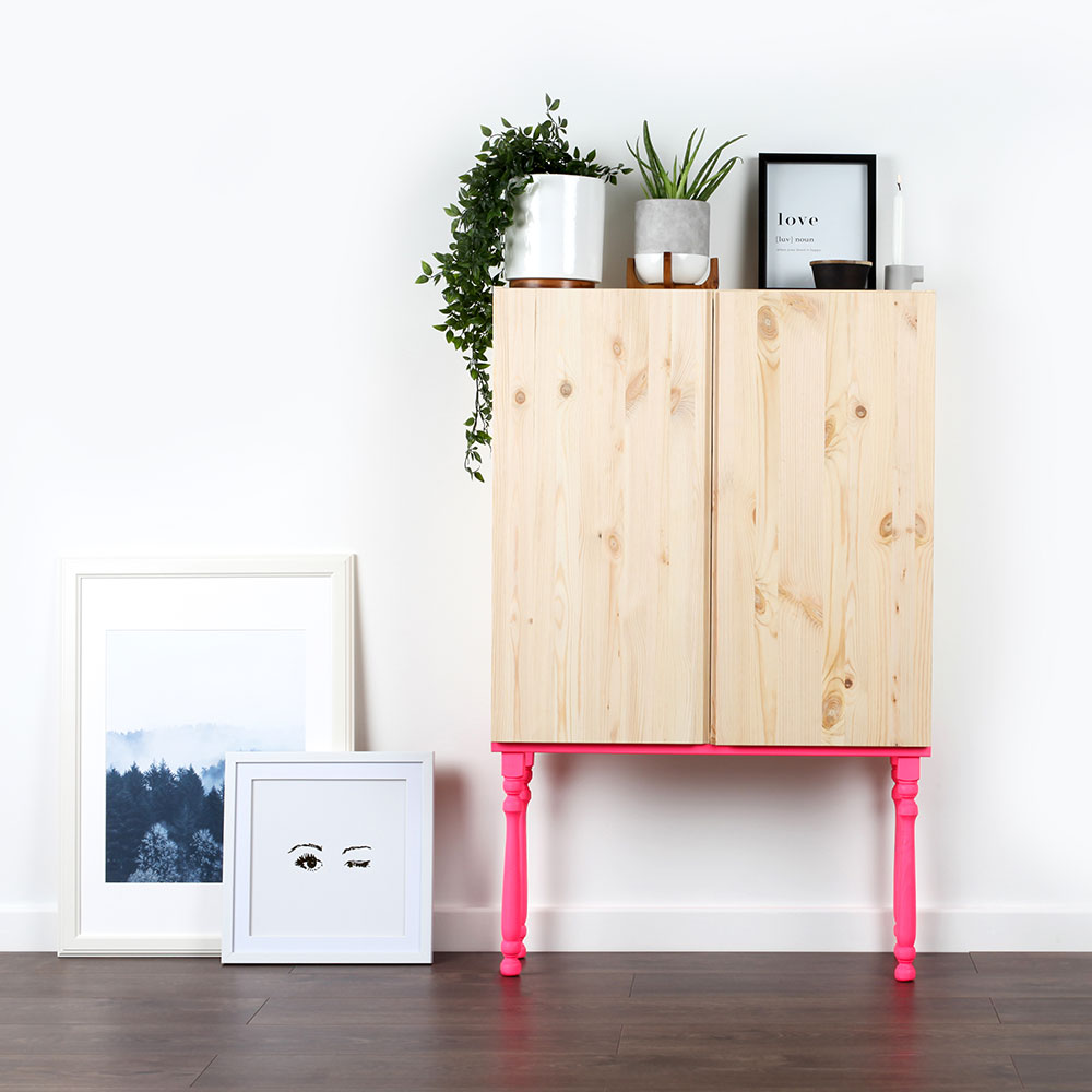 white room with cabinet and potted plant