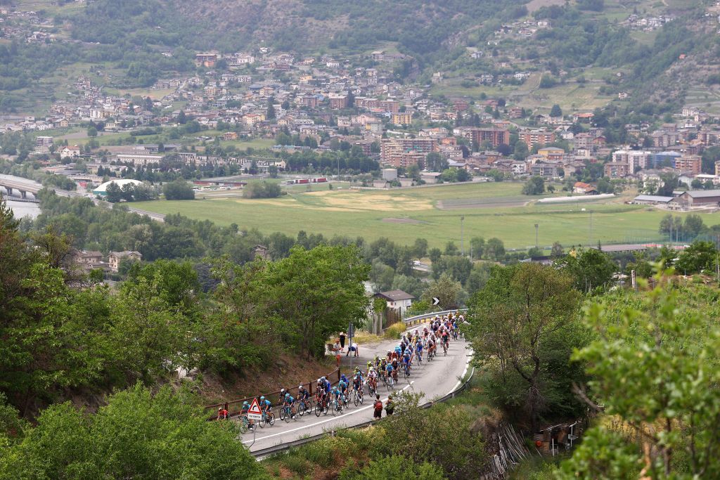 COGNE ITALY MAY 22 A general view of the Peloton passing through Pila Les Fleurs 1408m during the 105th Giro dItalia 2022 Stage 15 a 177km stage from Rivarolo Canavese to Cogne 1622m Giro WorldTour on May 22 2022 in Cogne Italy Photo by Michael SteeleGetty Images