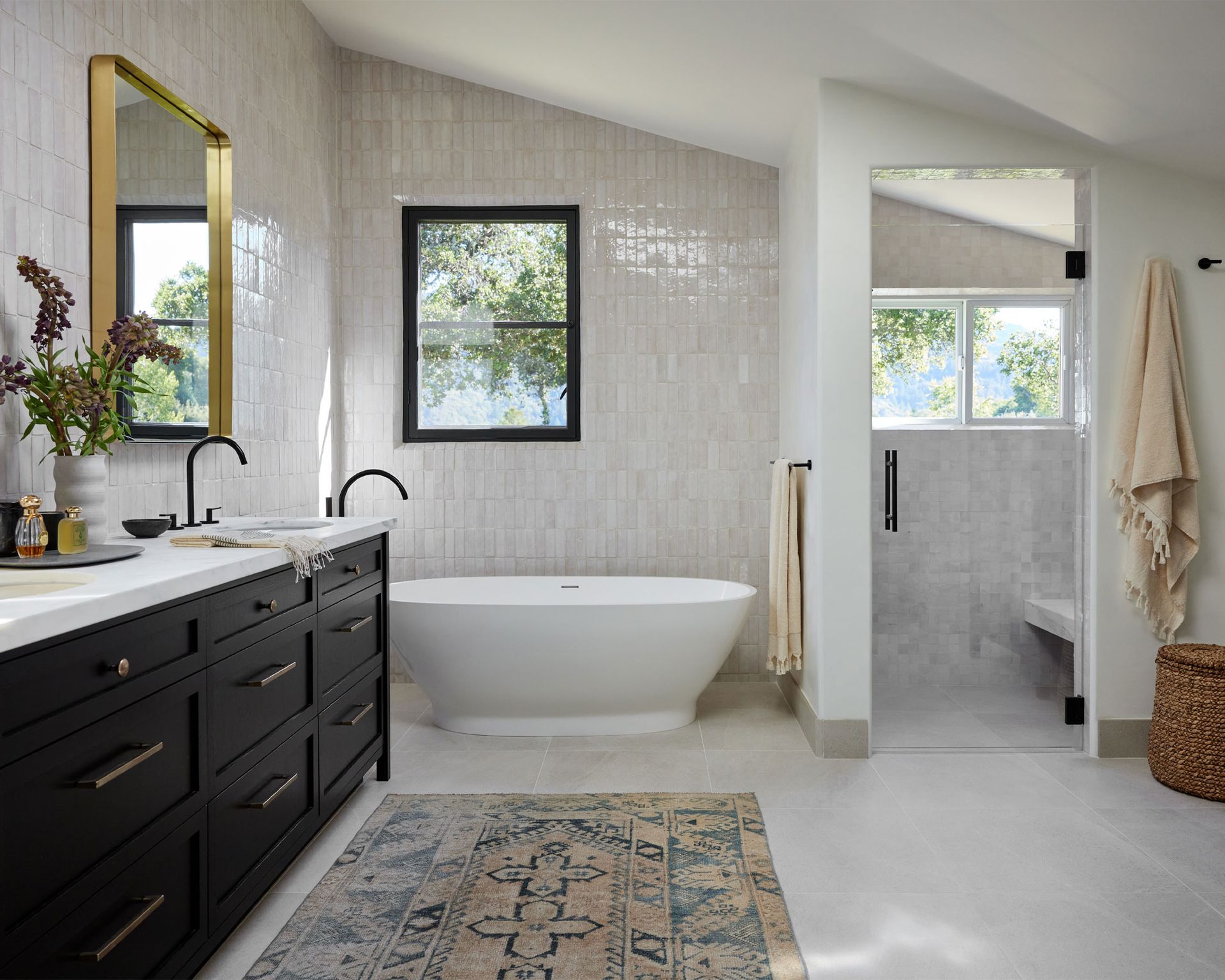 Large bathroom with bath, double vanity, rug and walk-in shower