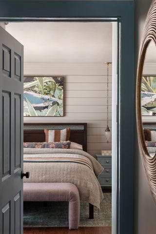 a bedroom with horizontal shiplap walls