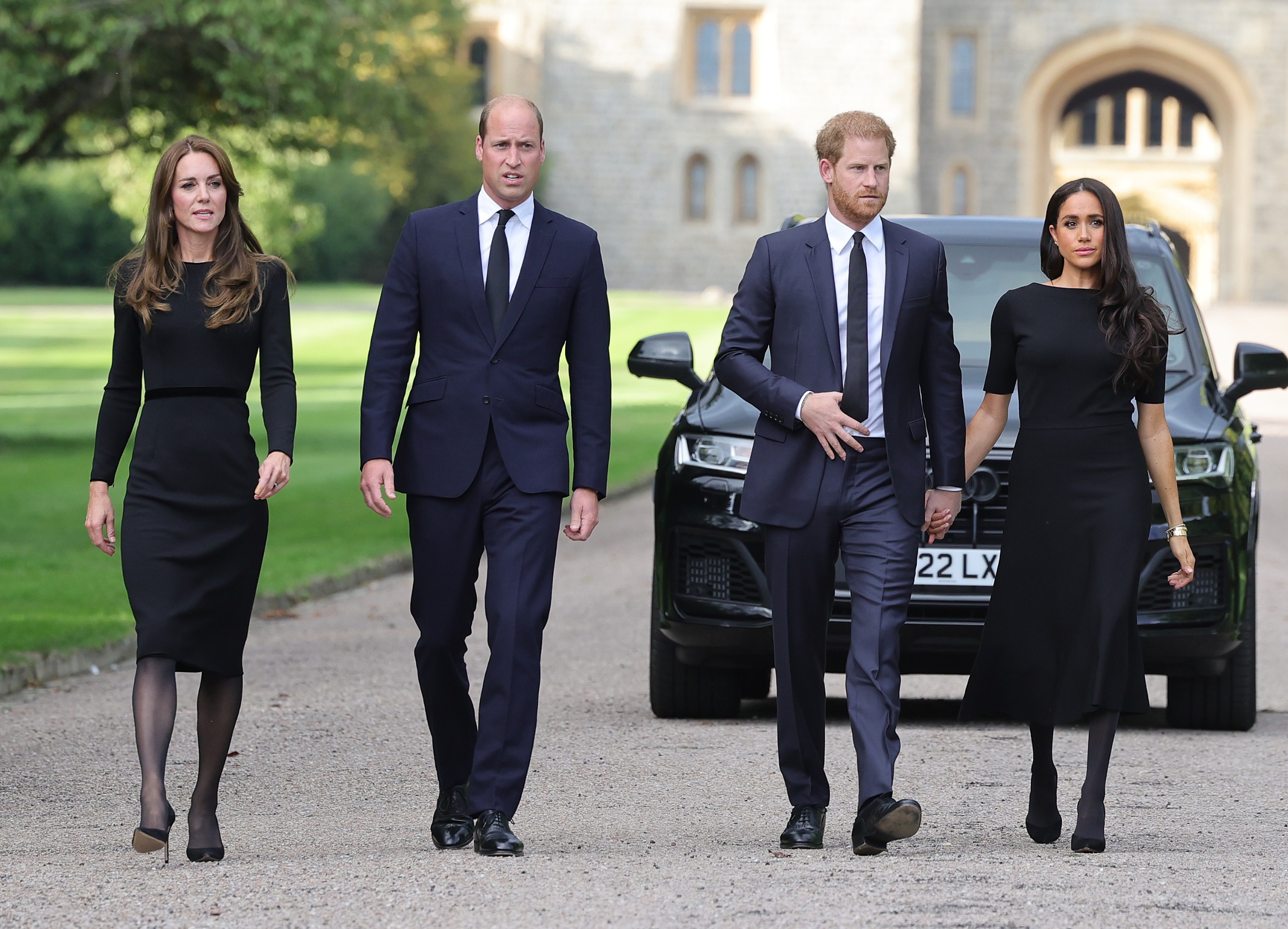 Princess Kate, Prince William, Prince Harry and Meghan Markle walking in a row at Windsor Castle