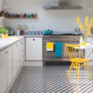 White kitchen with geometric floor tiles and yellow and blue accessories