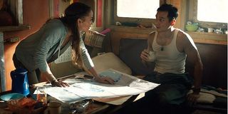 Tomb Raider Lara Croft Lu Ren Alicia Vikander Daniel Wu looking over a map in the ship's cabin