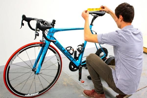 Ken Ballhause checks the angle of Robbie Hucker's saddle