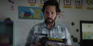Ghostbusters Afterlife Paul Rudd holds a ghost trap curiously