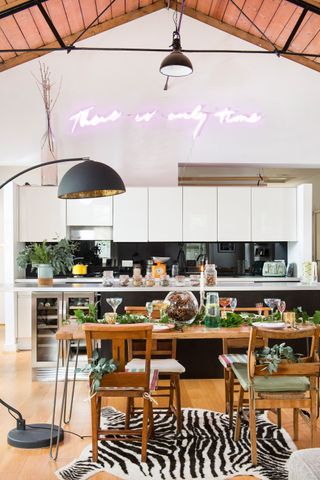 modern kitchen with an open plan dining room, large floor lamp and festive decorations