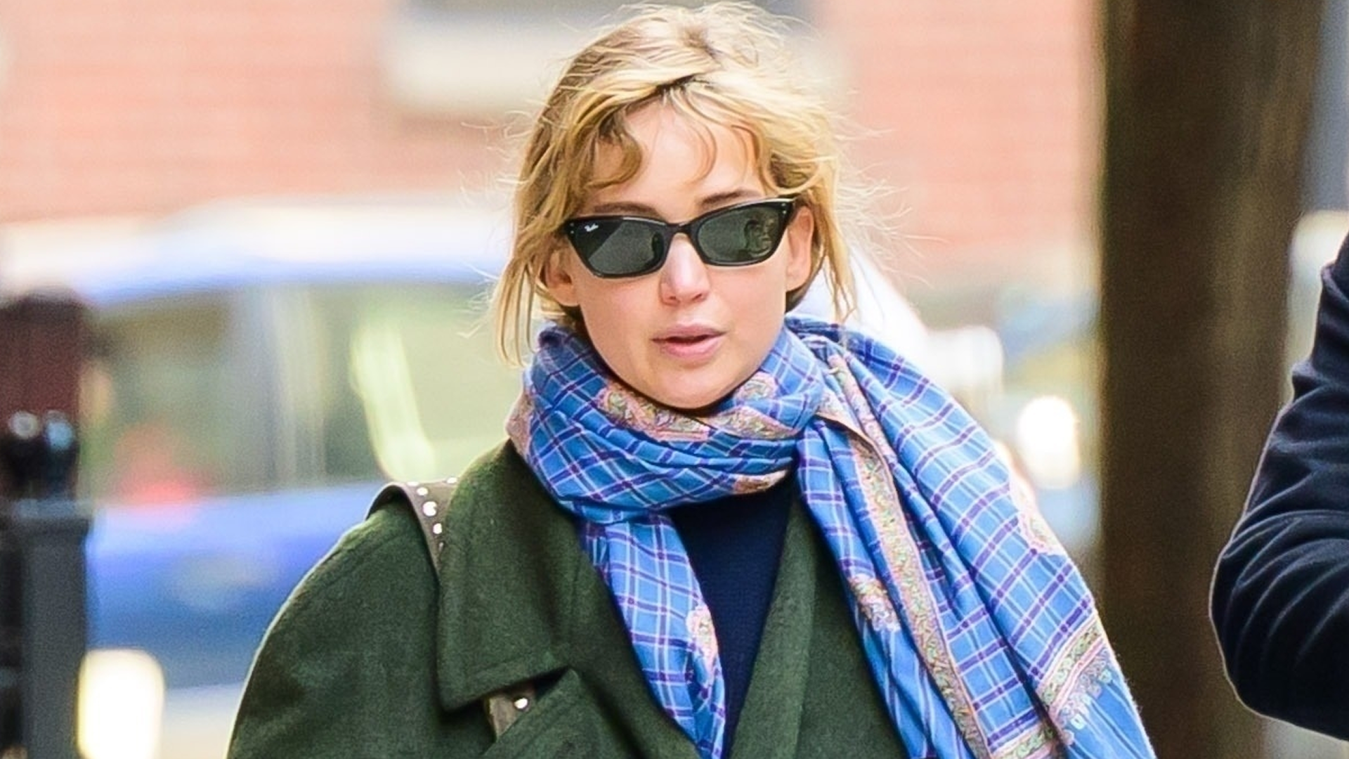 Jennifer Lawrence went for a walk in a green The Row coat, red track pants, and hiking sneakers