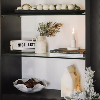 netural christmas decor on a black shelf by jamie young co.