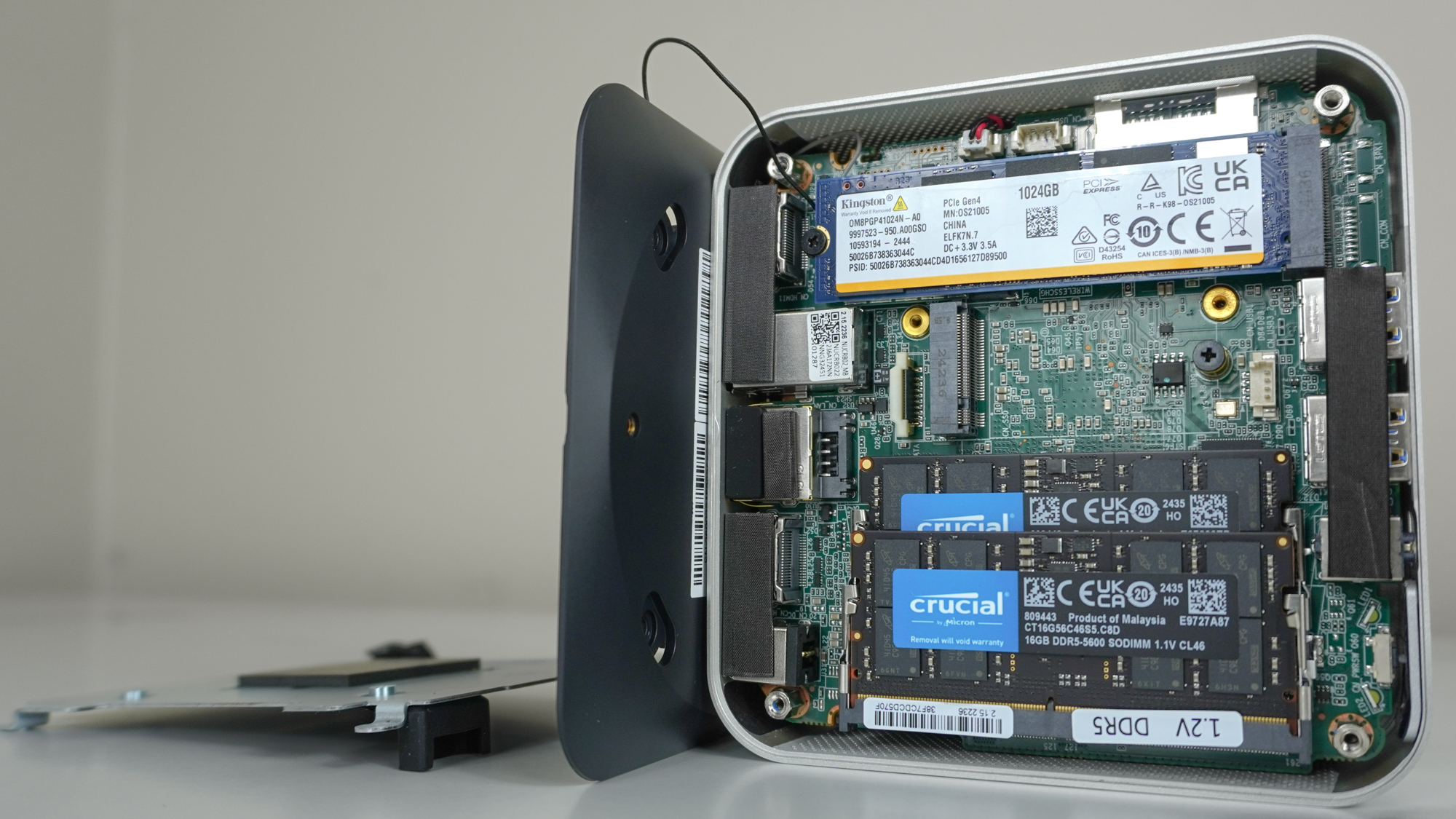 The Geekom A6 with its bottom panel removed showing its RAM, SSD and motherboard