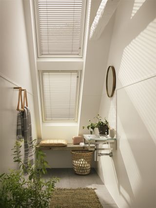 Velux Venetian blinds in a white and minimal loft conversion en suite