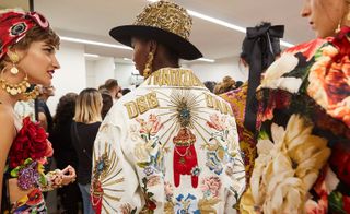 Models wear floral top and embroidered white jacket