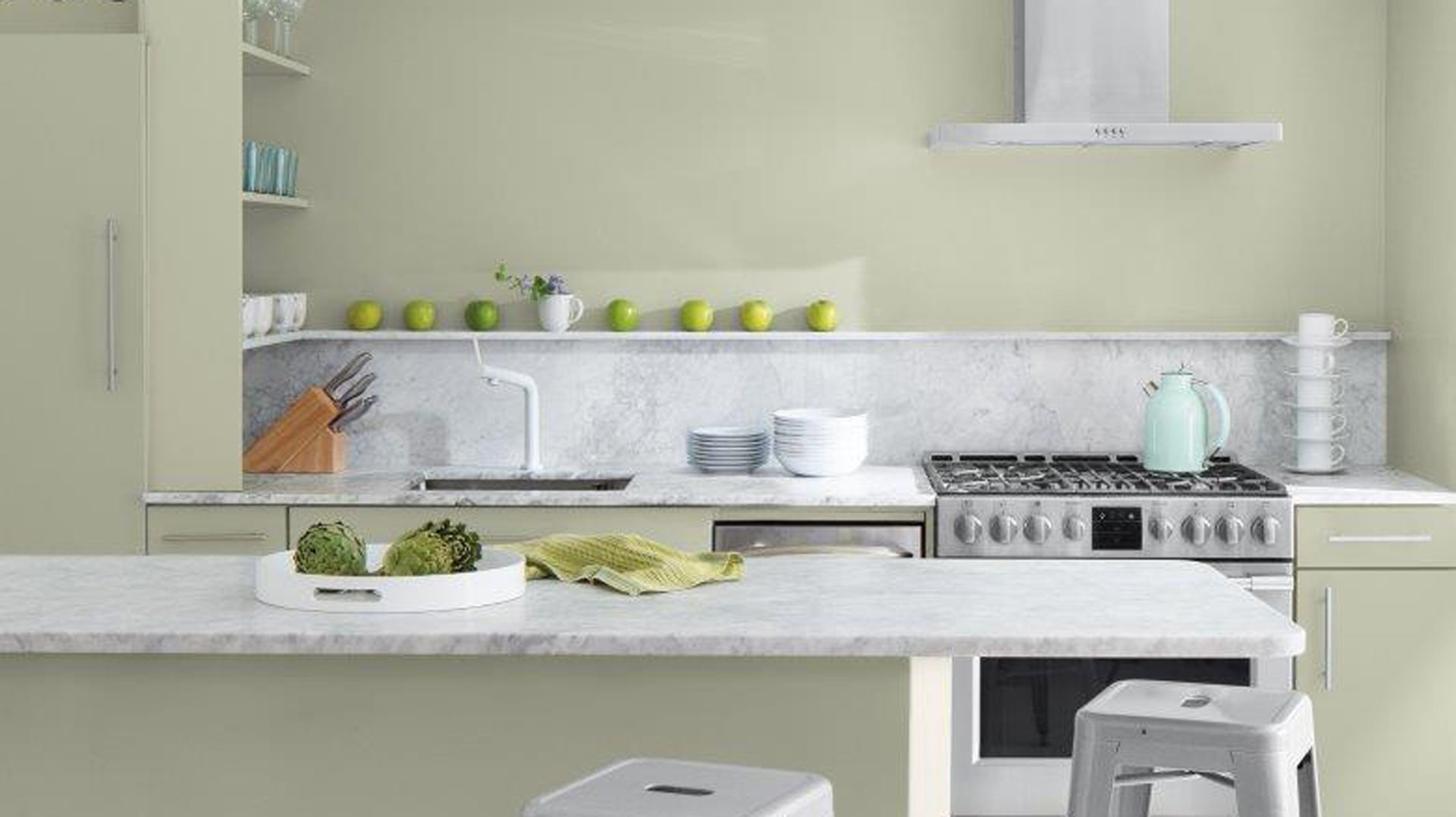 Sage green contemporary kitchen design with white marble worktops