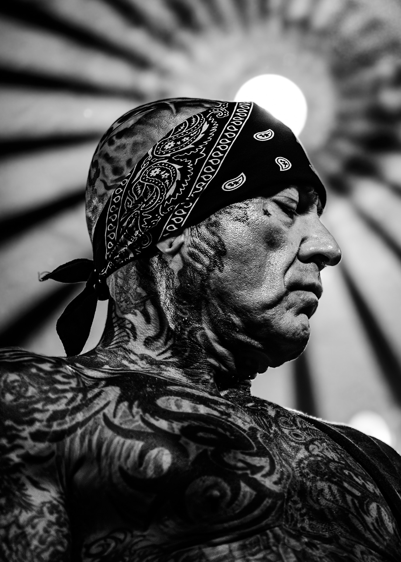 Close-up photo of Evan Seinfeld of the band Biohazard, placed in a perfect halo that matches the tattoos of the artist.