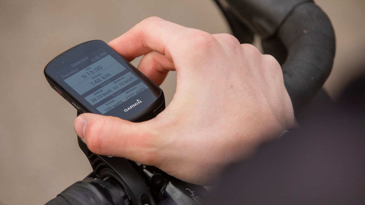 Male cyclist adjusting the screen on his cycling computer