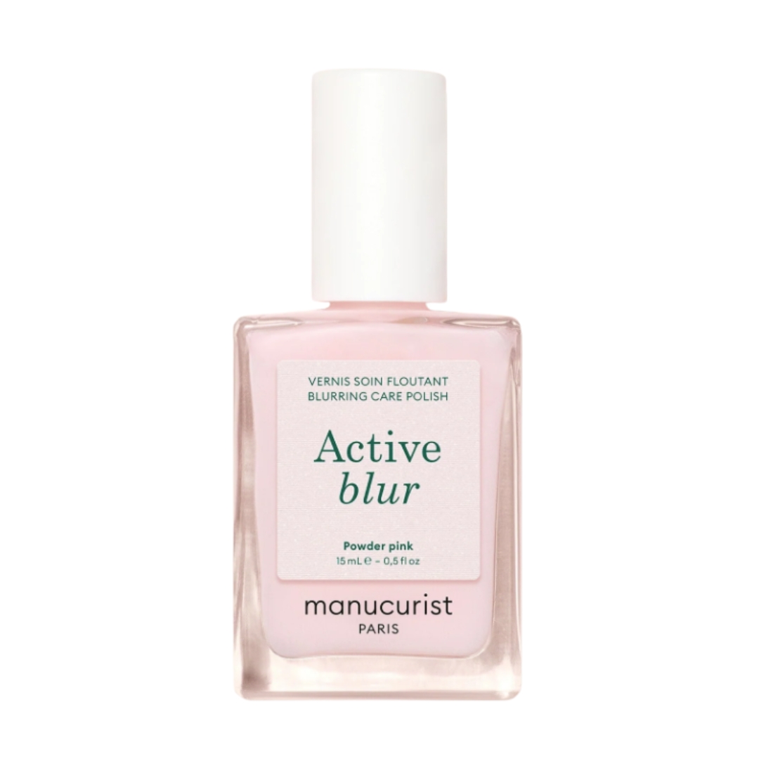 A product shot of the Manucurist Active Blur nail polish (which is a powder pink colour), on a white background