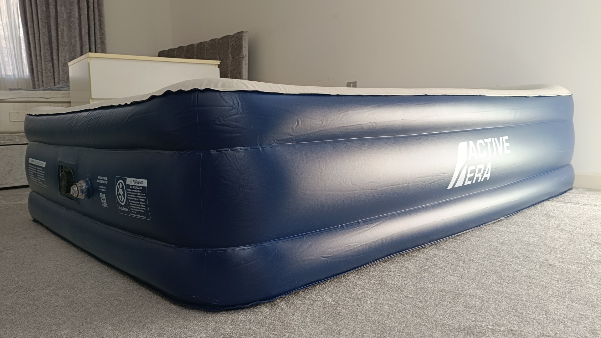 Corner of Active Era Air Mattress on floor in bedroom