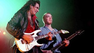 Steve Vai and Devin Townsend performing onstage in 1993