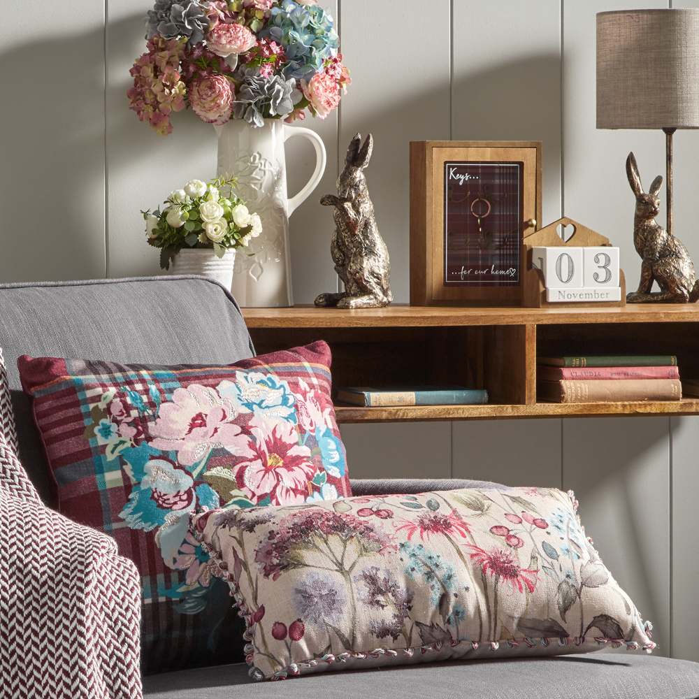 flower in vase with cushion and books