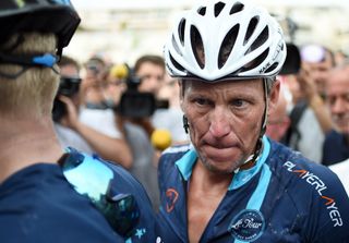 Lance Armstrong looks on upon his arrival in Rodez, southwest France, after riding a stage of The Tour De France for a leukaemia charity
