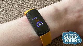 A Fitbit Inspire 3 on a wrist, with a badge saying 'TechRadar Sleep Week 2023'