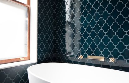 A bathroom with blue tiles in interesting patterns