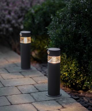 solar powered lights from garden trading along path