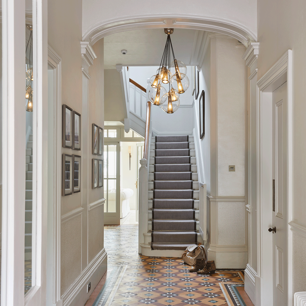hallway with carpet flooring and staircase