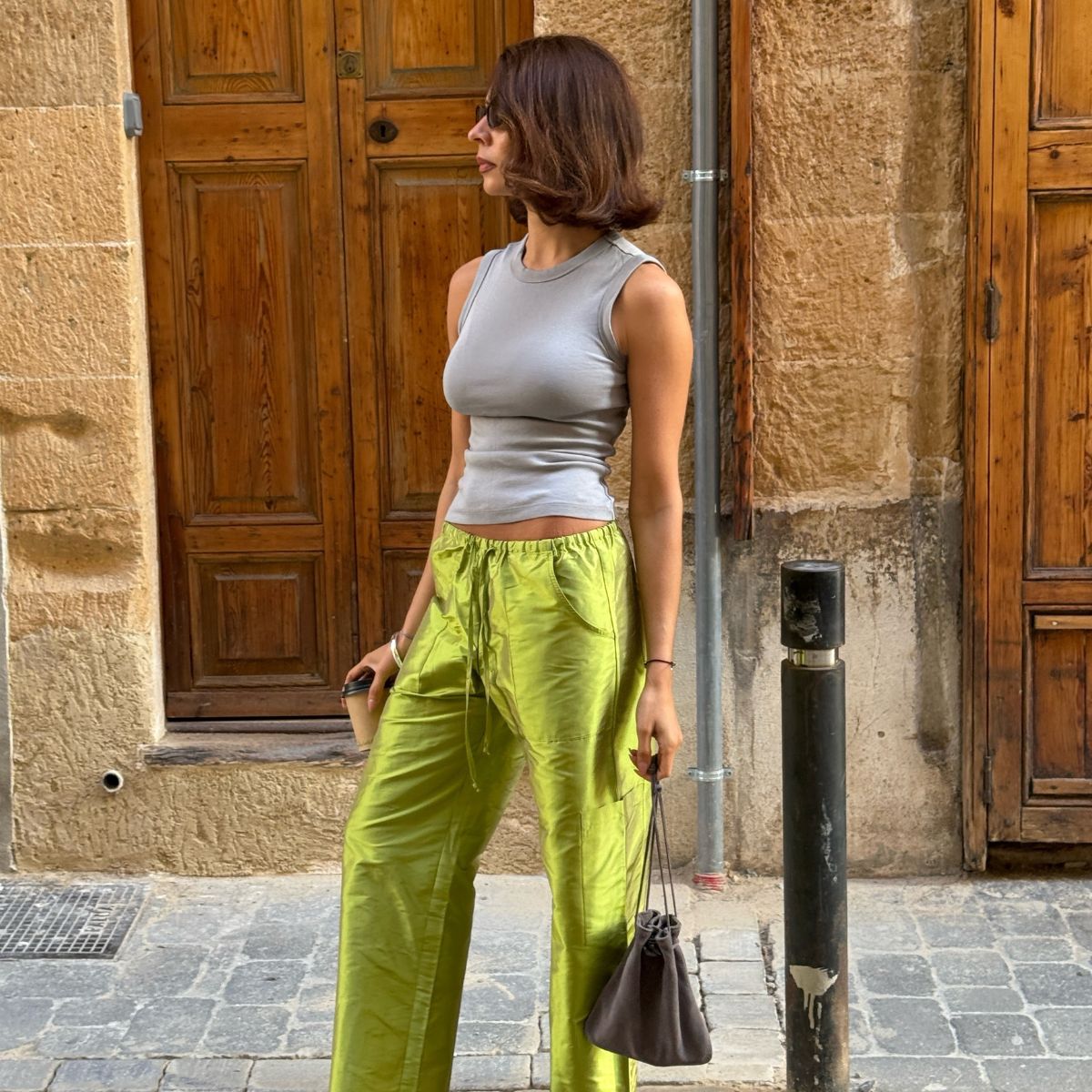 Marianne Smyth wearing a pair of bright green trousers and a grey vest in Spain