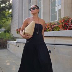 A woman walks outside in a garden