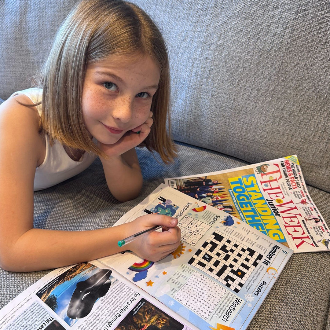 Child doing a puzzle in The Week Junior